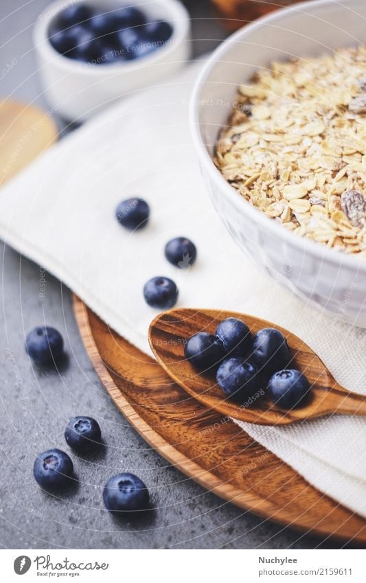 organic fresh blueberry and cereal Fruit Nutrition Breakfast Organic produce Diet Bowl Spoon Healthy Eating Paper Wood Fresh Delicious Natural White background