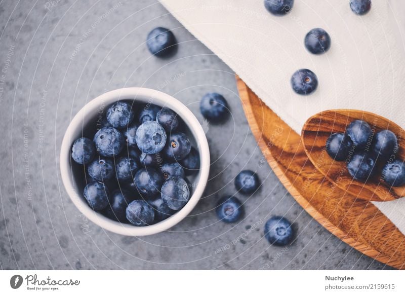 Top view of organic fresh blueberries Fruit Nutrition Breakfast Organic produce Diet Bowl Spoon Healthy Eating Paper Wood Fresh Delicious Natural White