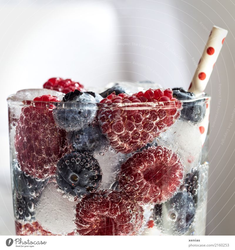 Fresh, juicy, cool. Half glass in detail with raspberries, blueberries, ice cream and drinking straw Beverage Fruit Raspberry Blueberry Berries Ice cube