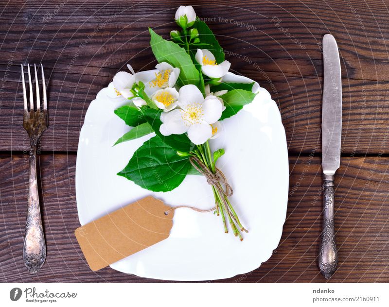 square white plate and iron cutlery Dinner Plate Cutlery Fork Decoration Kitchen Restaurant Flower Paper Wood Metal Old Above Brown White Jasmine etiquette