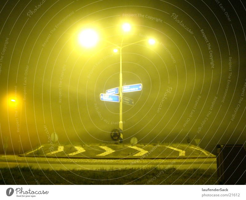 Roundabout in yellow Traffic circle Fog Night Lantern Long exposure yellow light Road marking