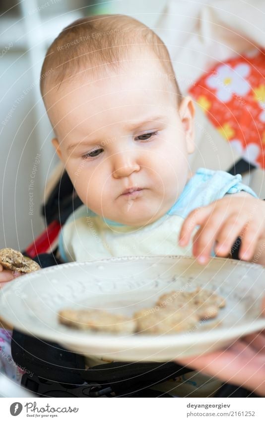 Baby eats alone. Eating Breakfast Lunch Spoon Chair Table Child Toddler Small Cute Appetite Loneliness biscuits Dish food girl healthy kid Meal kids Home