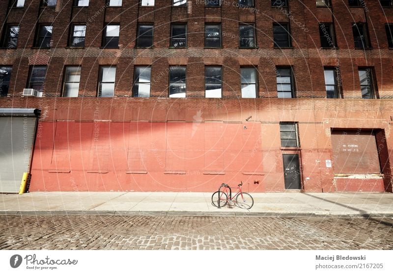 Bicycle on an empty street at sunset, New York City. Town Building Wall (barrier) Wall (building) Facade Transport Cycling Street Old bike Brooklyn NYC Sidewalk