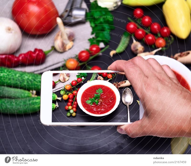 smartphone in the human hand Vegetable Soup Stew Nutrition Lunch Dinner Vegetarian diet Diet Plate Spoon Table Kitchen PDA Hand Wood Fresh Red White Tradition