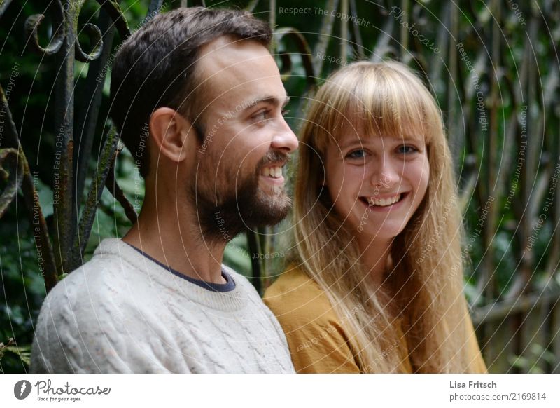 smiling young couple Friendship Couple Partner Adults 2 Human being 18 - 30 years Youth (Young adults) Environment Fence Long-haired Bangs Facial hair Observe