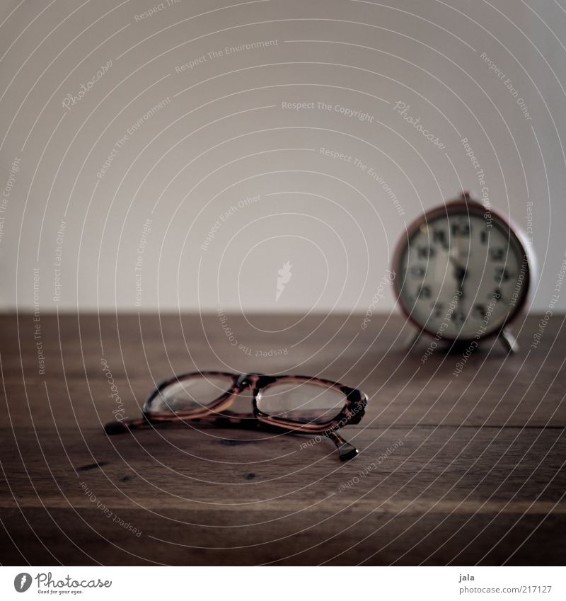 Five more minutes... Flat (apartment) Alarm clock Clock Eyeglasses Table Wood Brown Gray Time Vision Colour photo Interior shot Deserted Copy Space top
