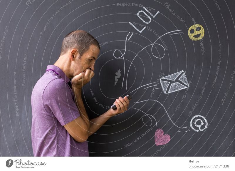 Concept of social media chat. Single white adult man standing in front of a blackboard using his smart phone Lifestyle Cellphone PDA Internet Masculine Man