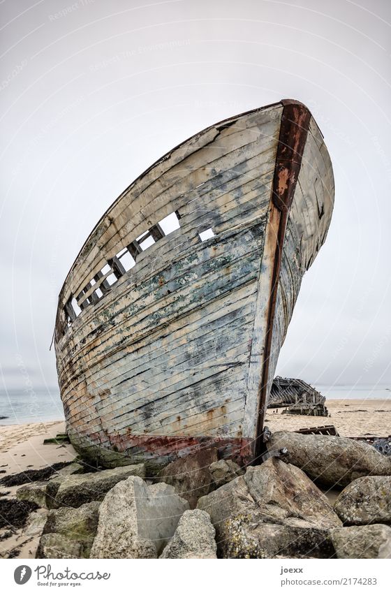From the time Horizon Rock Fishing boat Wood Old Tall Maritime Blue Brown Loneliness Idyll Death Destruction Wreck Decompose Colour photo Subdued colour