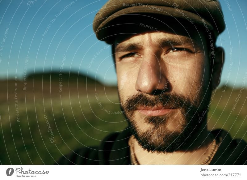 Has trick Masculine 1 Human being Blue Brown Green Cap Facial hair Meadow Sky Beautiful weather Eyes Far-off places Meditative Colour photo Exterior shot