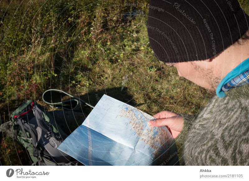A young man with an Iceland sweater studies a hiking map Vacation & Travel Trip Adventure Mountain Hiking Young man Youth (Young adults) Nature Map Study