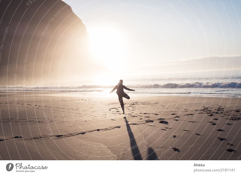 Young woman dancing on the beach in the sunset Playing Vacation & Travel Adventure Far-off places Freedom 1 Human being Nature Sun Mountain Waves Beach Ocean