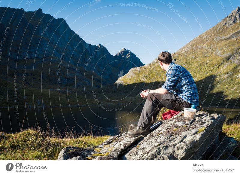 Young man in mountain landscape, lunch break, Norway, Lofoten Well-being Contentment Relaxation Calm Leisure and hobbies Trip Adventure Mountain Hiking