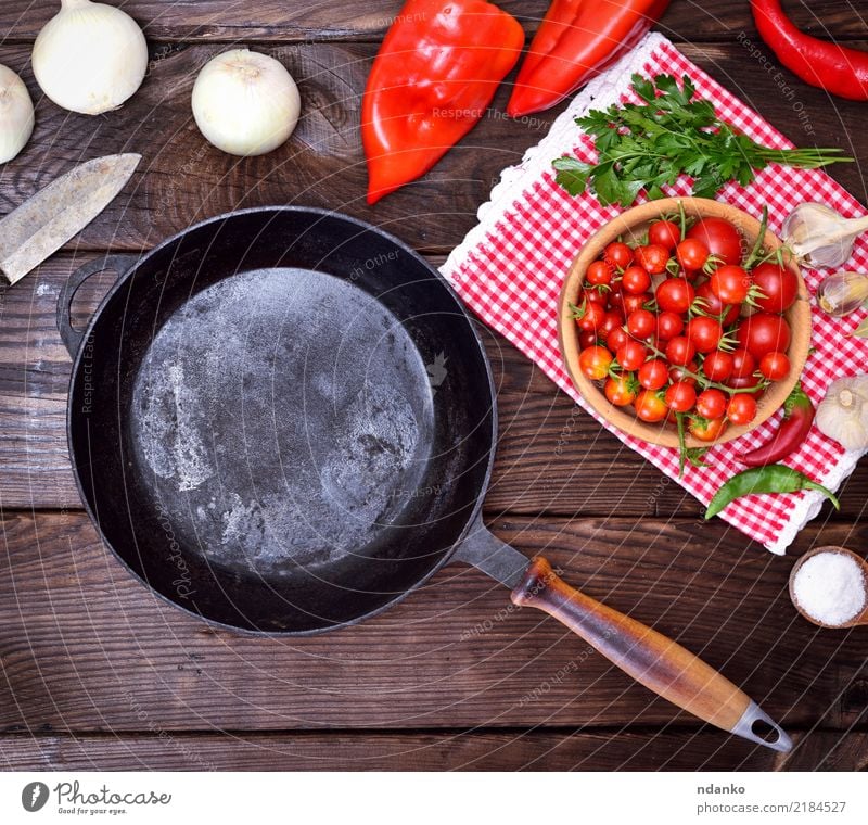 empty black cast-iron frying pan Food Vegetable Nutrition Eating Pan Knives Kitchen Wood Brown Red Black round Cast iron Tomato Onion salt knife ripe cook