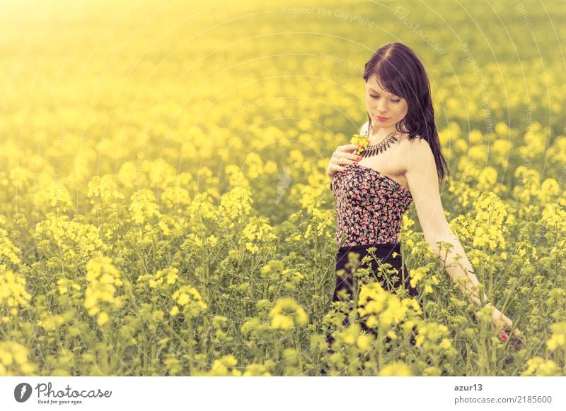 Pretty girl in youth summer sun with yellow nature flowers. Young woman is attractive, authentic and beautiful. Relaxation and peace from stress, love for environment and dream rest in soul full of happiness.