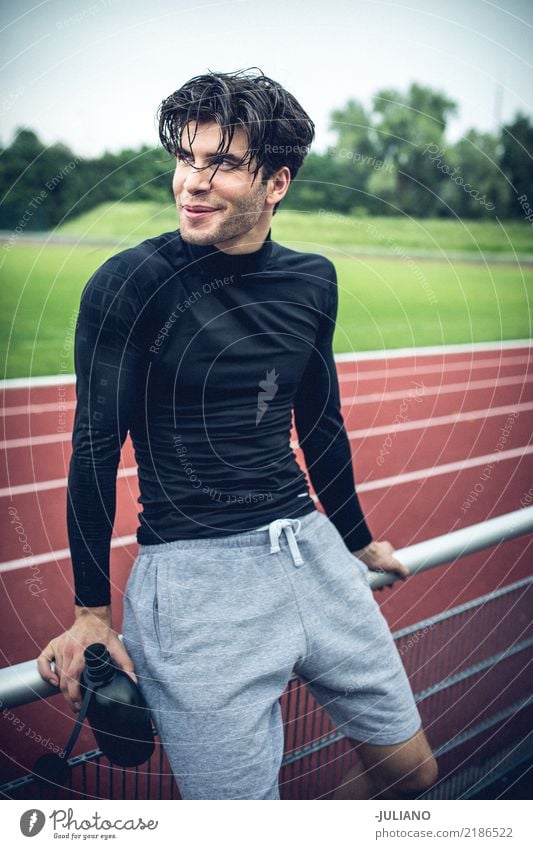 sports man is taking brake at running track Nutrition Drinking water Lifestyle Leisure and hobbies Sports Fitness Sports Training Track and Field Sportsperson