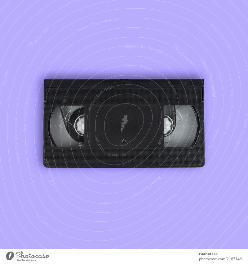 VHS tape isolated over mauve background video bkack Video record equipment obsolete technology vintage old 80s plastic retro media