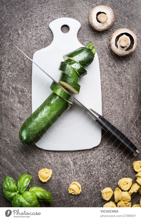 Green cut zucchini on chopping board Food Vegetable Herbs and spices Nutrition Lunch Organic produce Vegetarian diet Diet Crockery Knives Style Design