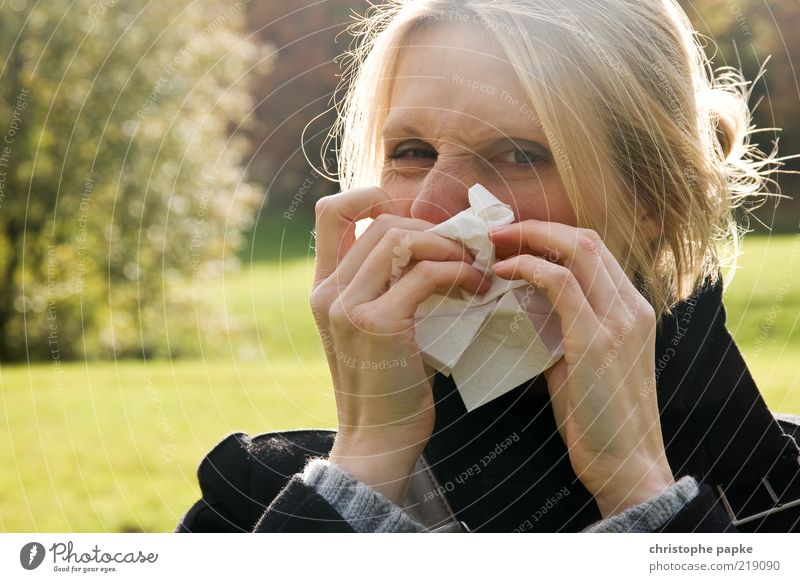Young blonde woman blows her nose Handkerchief Common cold Allergy Blonde Illness Young woman Face 1 Human being Sniff defenses Virus immune system