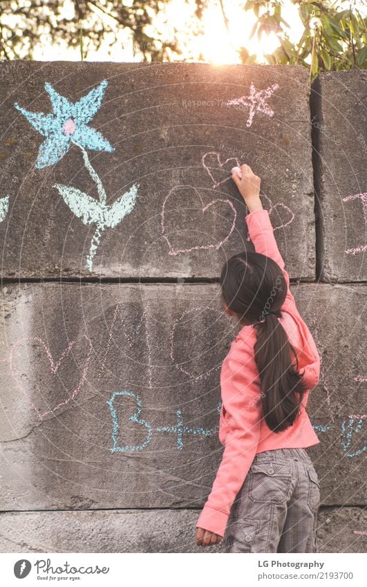 Young girl with brown hair is playing outside. Happy Beautiful Playing Summer Sun Human being Woman Adults Art Flower Graffiti Cute Pink Safety Colour artistic