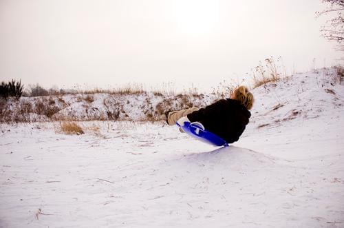 PANCAKE SLIDE Joy Leisure and hobbies Playing Winter Snow Human being Masculine Boy (child) Infancy 1 Environment Nature Landscape Sky Movement Sledding Skid
