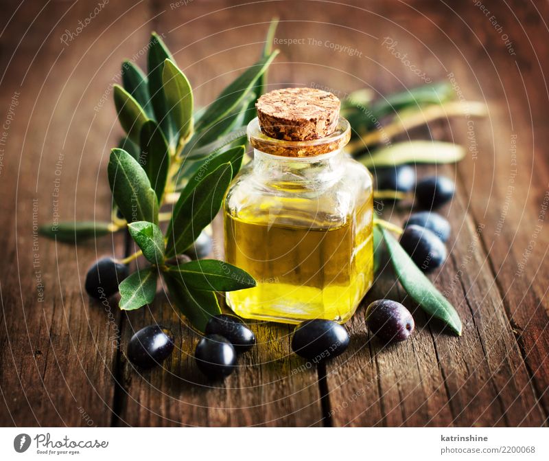 Olive oil and fresh olives on rustic wood background Vegetable Nutrition Diet Bottle Leaf Dark Fresh Natural Retro Brown Yellow Green Branch Extra Flavor Food