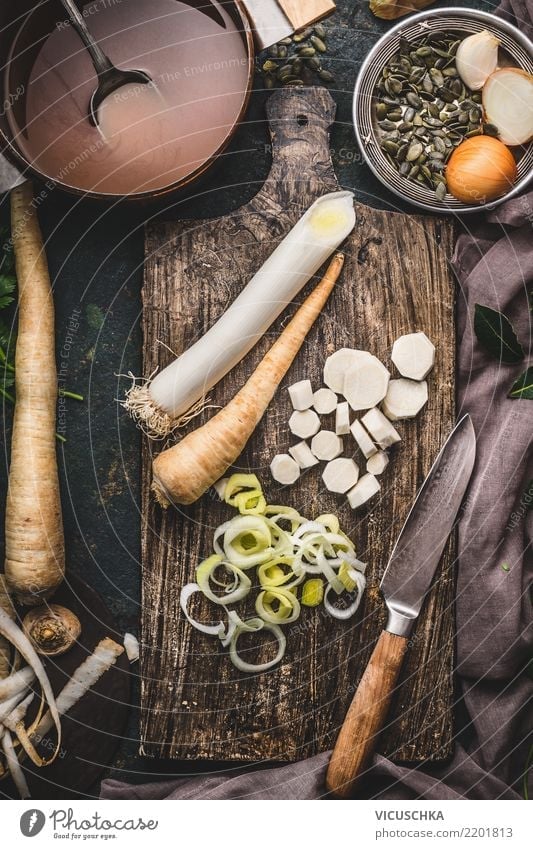 Leek and parsnip on chopping board Food Vegetable Soup Stew Nutrition Organic produce Vegetarian diet Diet Crockery Pot Knives Style Design Healthy Eating