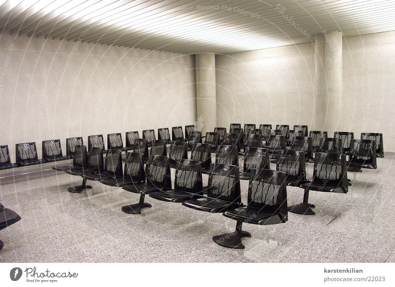 Waiting room in grey Waiting area Bench Row of seats Hall Concrete Gray Black Impersonal Architecture seating group Warehouse artificial light
