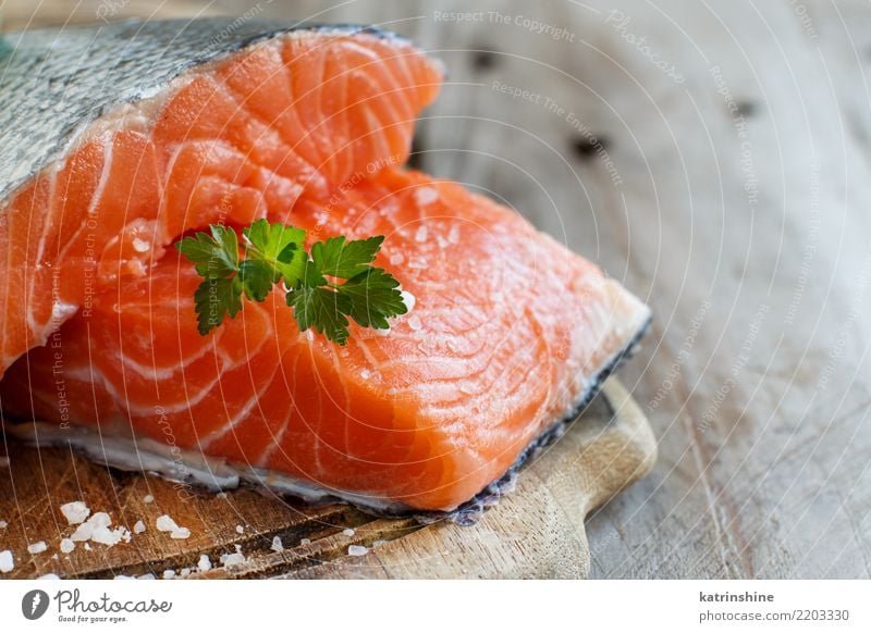 Fresh raw salmon on a wooden cutting board Fish Seafood Nutrition Eating Dinner Diet Table Green Red background cooking fillet healthy Ingredients Meal Portion