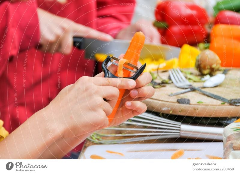 collective cooking Cooking Teamwork potato peeler Carrot Pepper Vegetable Child Molt Chopping board Cut Healthy Eating Youth (Young adults) Hand Colour photo