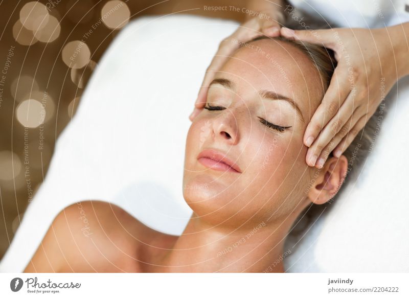 Young blond woman receiving a head massage in a spa center Lifestyle Beautiful Skin Face Health care Medical treatment Wellness Relaxation Spa Massage