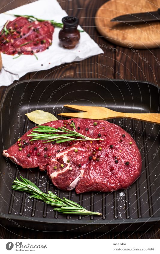 raw beef steak Meat Herbs and spices Dinner Pan Fork Table Kitchen Paper Wood Eating Fresh Red Black background Beef Blood board butcher Chop close cooking Cut