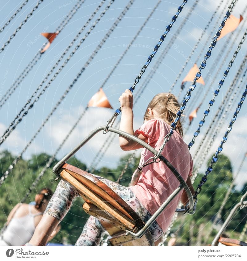 Young girl driving a chain carousel Lifestyle Joy Happy Fitness Harmonious Contentment Relaxation Vacation & Travel Summer Summer vacation Sun Event