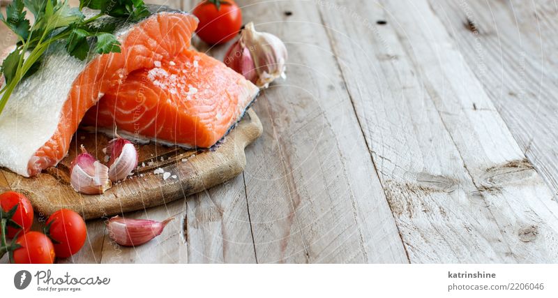 Fresh raw salmon on a wooden cutting board Fish Vegetable Herbs and spices Nutrition Eating Dinner Diet Table Red background cooking fillet food healthy