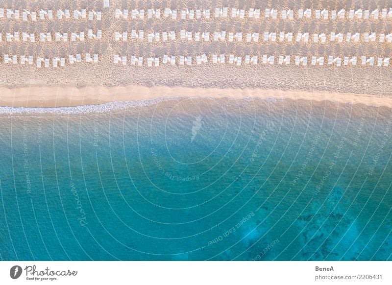 Deckchairs on a sand beach at the turquoise blue sea from above Lifestyle Exotic Relaxation Swimming & Bathing Vacation & Travel Tourism Trip Adventure