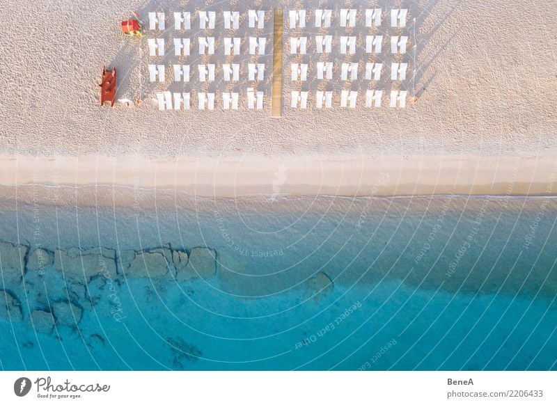 Deckchairs on a sand beach at the turquoise blue sea from above Lifestyle Exotic Relaxation Swimming & Bathing Vacation & Travel Tourism Trip Adventure