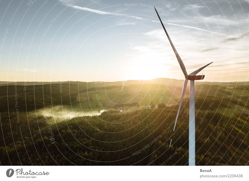 Wind turbine in a forest at sunset from above Economy Industry Energy industry Technology Advancement Future High-tech Renewable energy Wind energy plant Nature