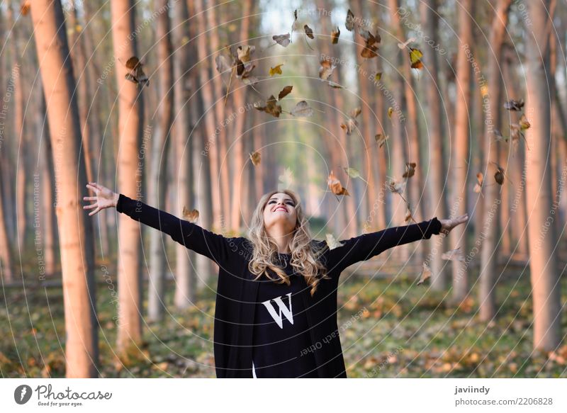 Woman playing with autumn leaves in forest Joy Happy Beautiful Face Playing Human being Adults Nature Autumn Leaf Park Blonde Smiling Love Happiness White