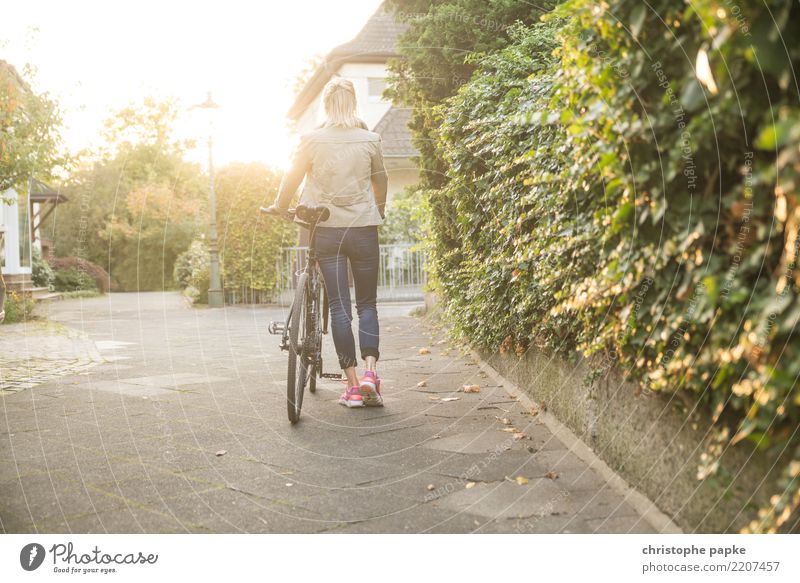 Who loves his bike, pushes it Contentment Cycling Bicycle Woman Adults 1 Human being 30 - 45 years Town Going Bright Push Colour photo Exterior shot
