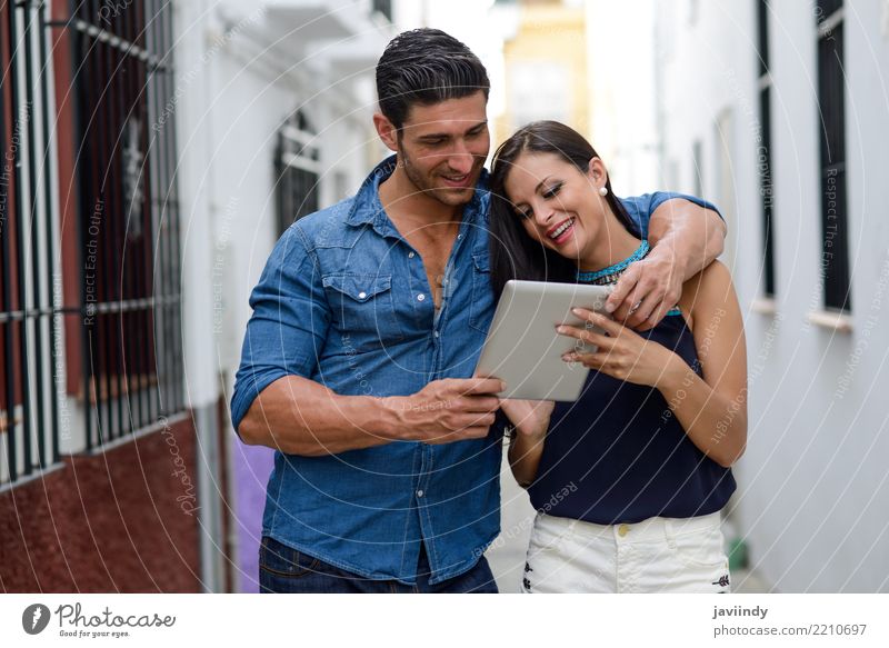 Couple with tablet computer in urban background Lifestyle Happy Beautiful Face Telecommunications Internet Human being Woman Adults Man Smiling Happiness Modern