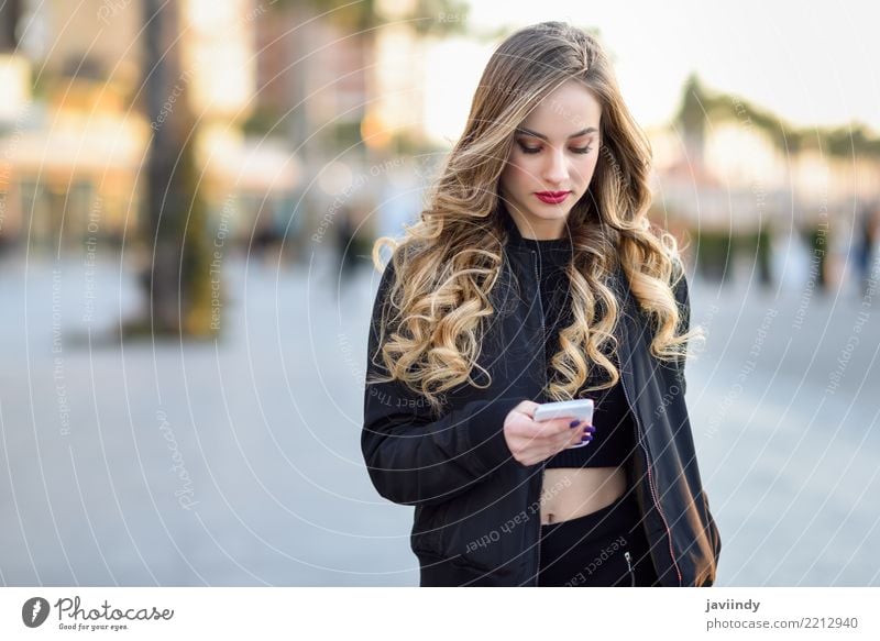Blonde woman texting with her smartphone Lifestyle Style Beautiful Hair and hairstyles Telephone PDA Human being Feminine Woman Adults 1 18 - 30 years