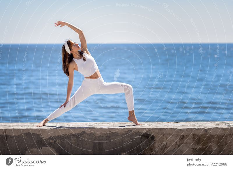 Young woman doing yoga in the beach. Lifestyle Beautiful Wellness Relaxation Meditation Summer Beach Ocean Sports Yoga Human being Feminine Woman Adults Body 1