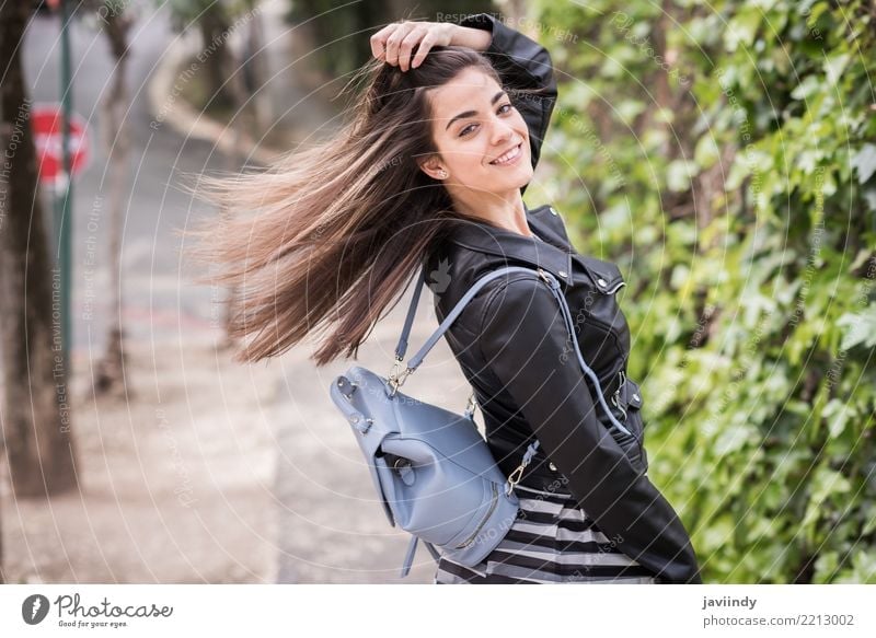 Young woman moving her hair in urban background Lifestyle Style Happy Beautiful Hair and hairstyles Human being Woman Adults Wind Street Fashion Skirt Jacket