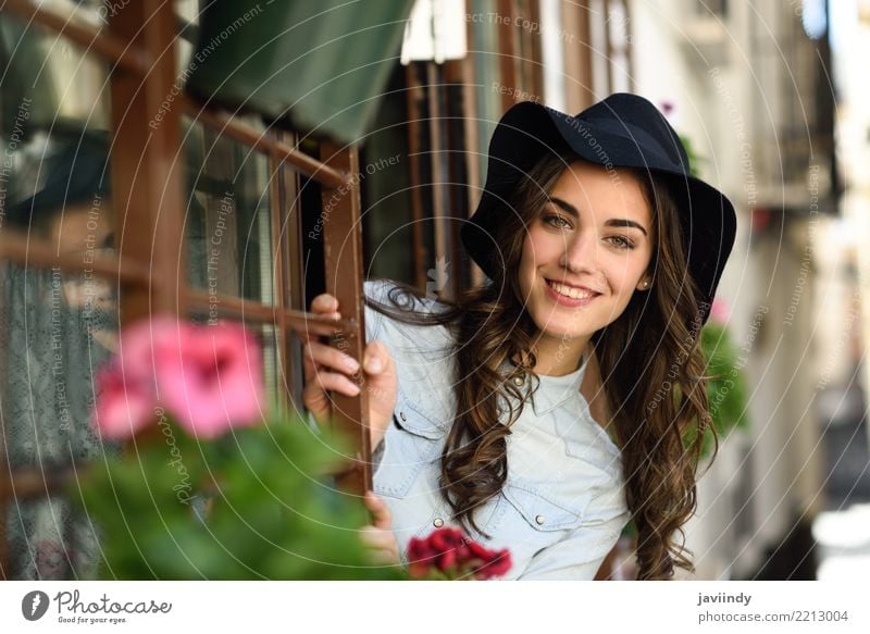 Young woman smiling with hat near a window Lifestyle Elegant Style Happy Beautiful Hair and hairstyles Face Human being Woman Adults Street Fashion Shirt Hat