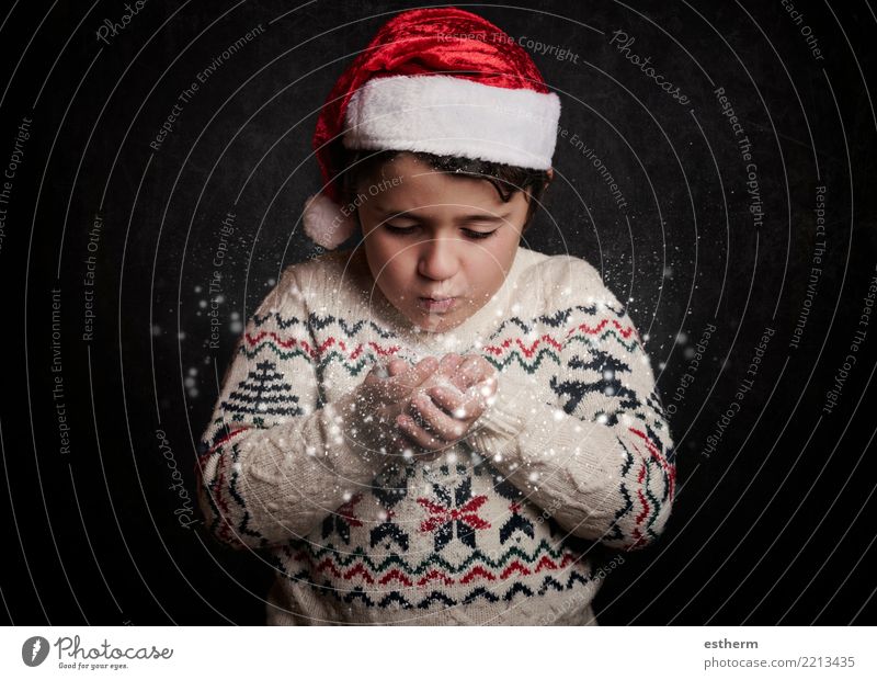 little child blows snow from hands in christmas Lifestyle Vacation & Travel Adventure Winter Party Event Feasts & Celebrations Christmas & Advent New Year's Eve