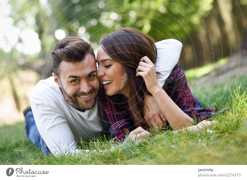 Beautiful young couple laying on grass in an urban park. Lifestyle Joy Happy Summer Human being Masculine Feminine Woman Adults Man Couple 2 18 - 30 years
