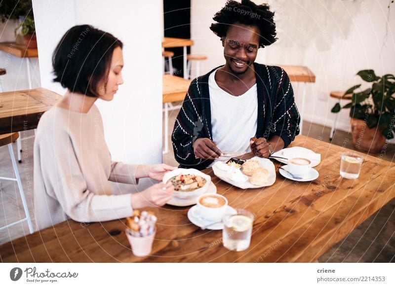 Mixed Race couple eating breakfast together in restaurant Food Eating Breakfast To have a coffee Beverage Drinking Coffee Espresso Bowl Lifestyle Joy Happy
