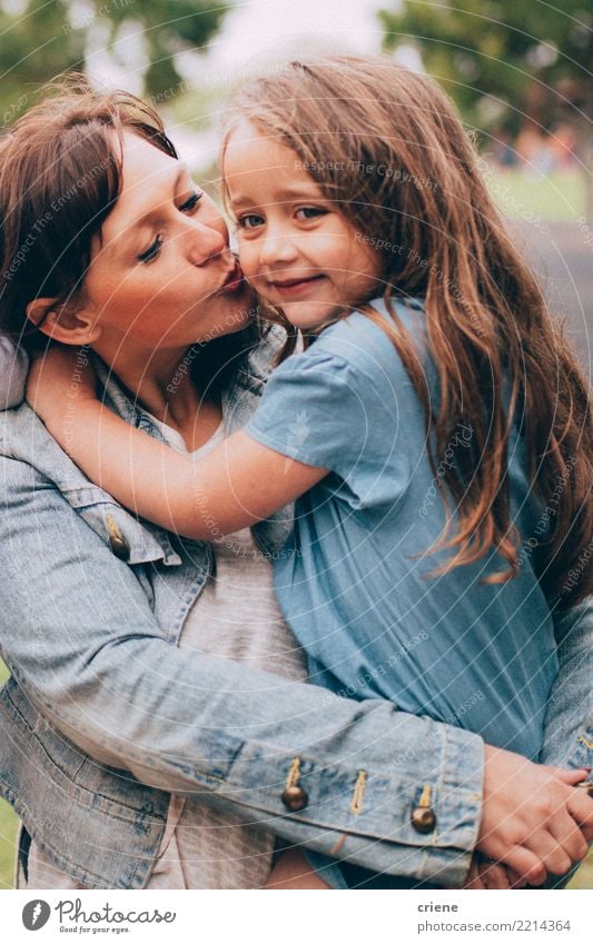 Mother giving cute little daughter a kiss on the cheek Lifestyle Joy Happy Leisure and hobbies Parenting Child Human being Feminine Girl Woman Adults