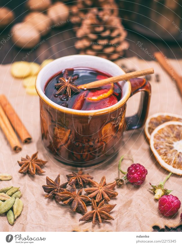 drink mulled wine in brown ceramic mug Fruit Herbs and spices Beverage Alcoholic drinks Mulled wine Cup Winter Decoration Table Feasts & Celebrations