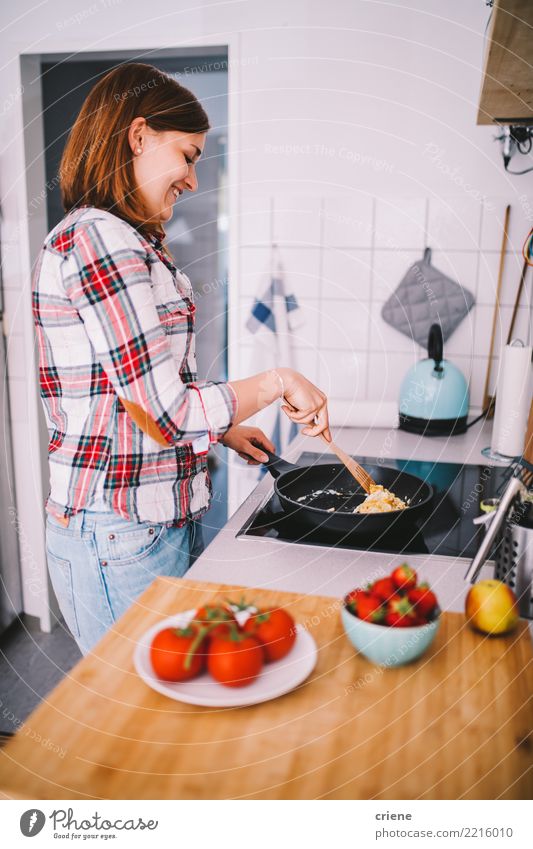 Woman preparing breakfast in the kitchen Vegetable Fruit Diet Pan Joy Happy Healthy Eating Kitchen Feminine Adults Youth (Young adults) Hot Bright Food stove