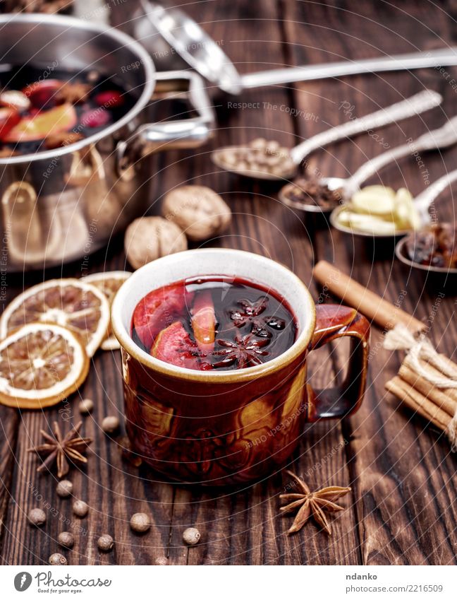 Mulled wine in brown mug Fruit Herbs and spices Beverage Alcoholic drinks Cup Spoon Winter Table Feasts & Celebrations Christmas & Advent Wood Hot Natural Brown